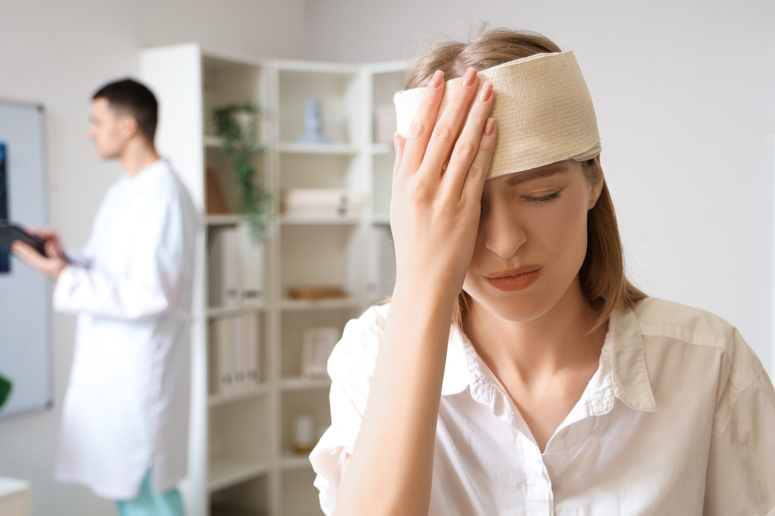 Young woman with brain concussion at doctor's office,
